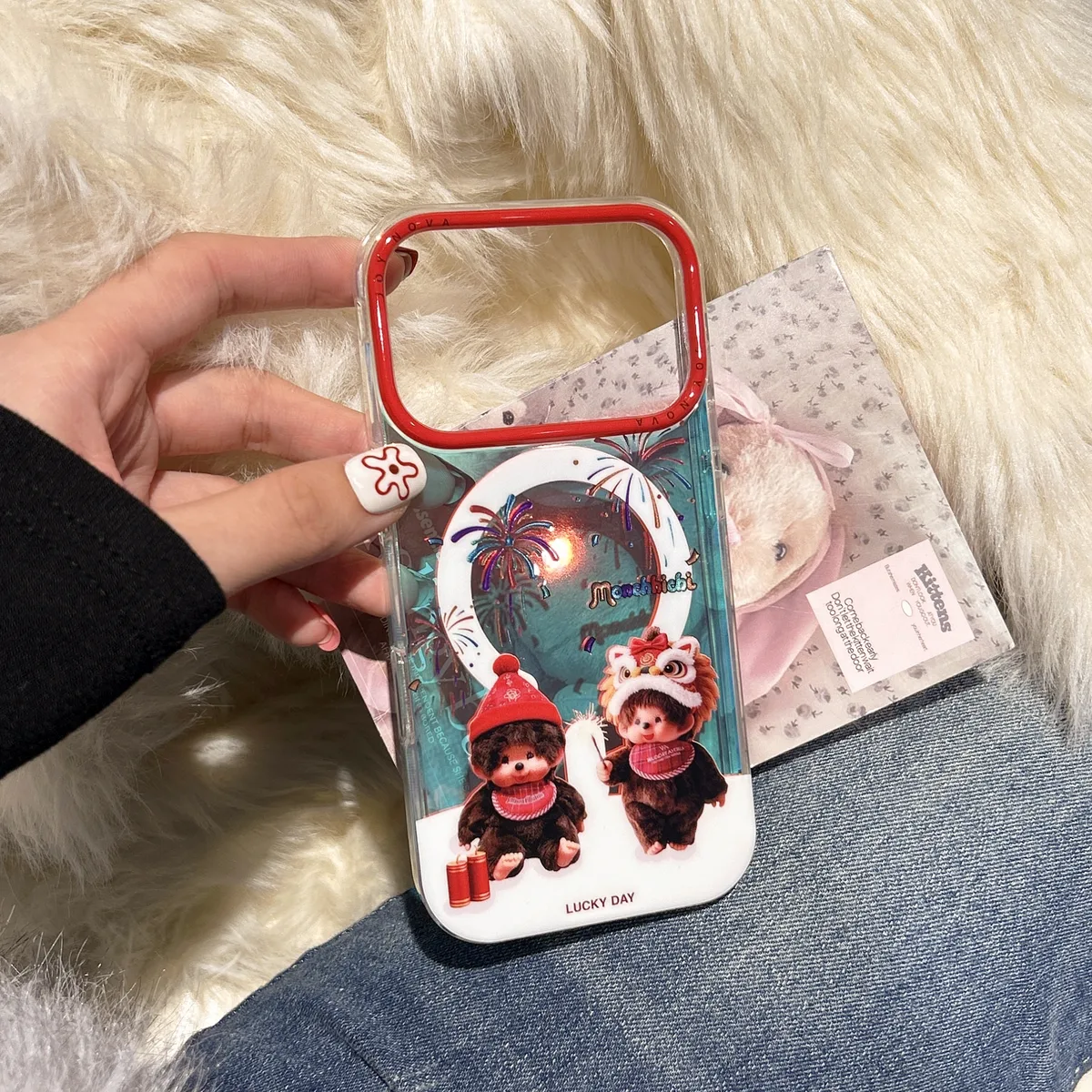 Clear phone case with Monchhichi Lucky Day artwork and a red camera frame